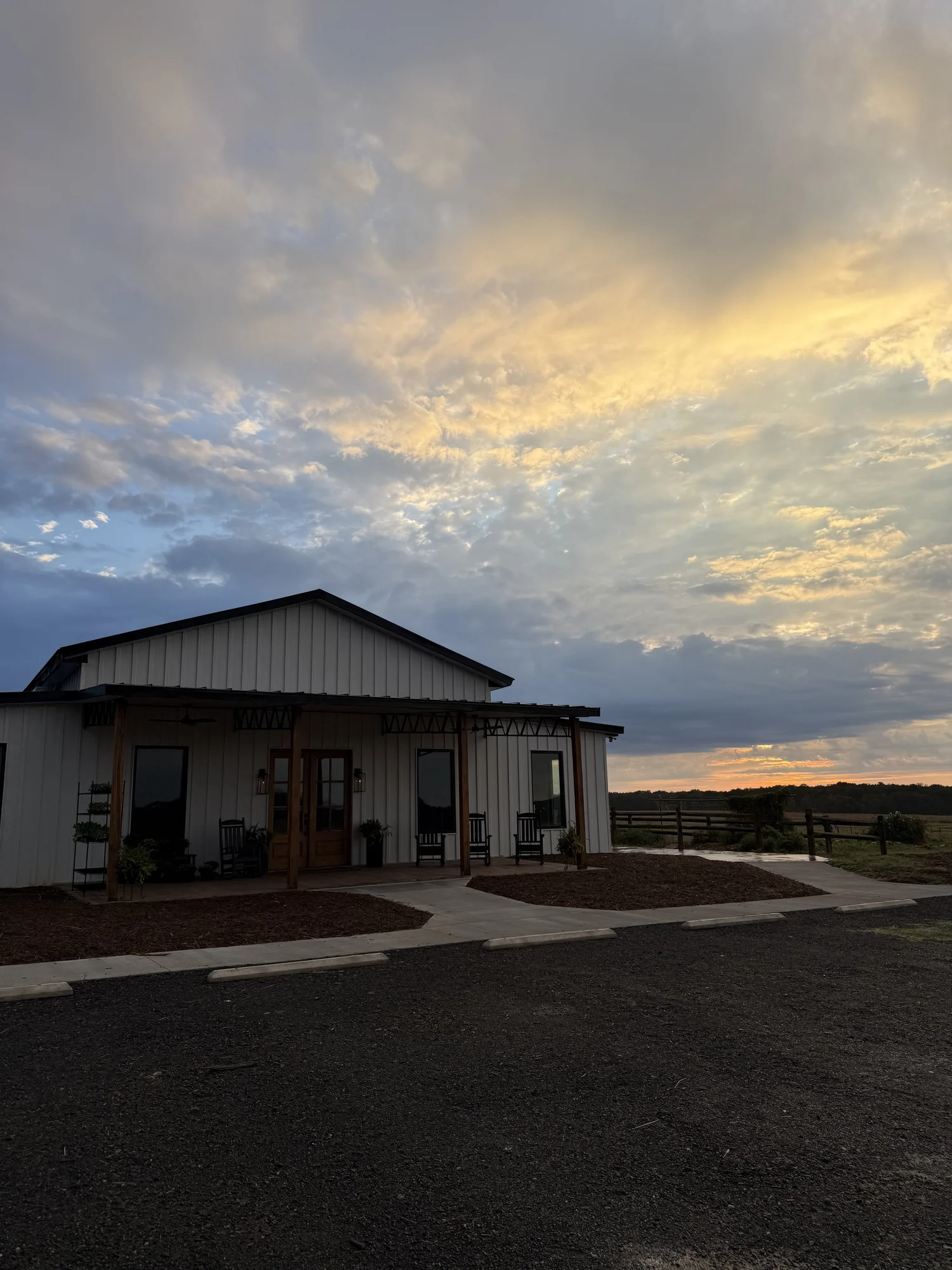 The T.E. Market building under a sunset sky